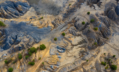 Aerial view of dunes of sand and clay in an abandoned quarry.