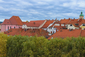 Scenic skyline of Maribor at autumn. Old part of the city. Stunning red tile roofs against cloudy sky. Maribor, Slovenia