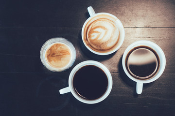 Cups of different flavors hot coffee drink like flat black, cappuccino, latte, and americano on the...