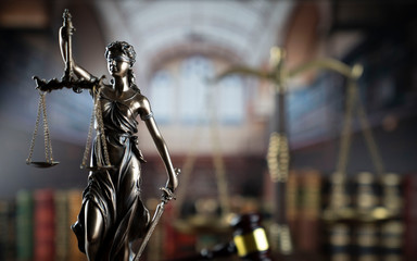  Law and justice theme.  Gavel of  the judge, Themis statue and the scale on court library background.