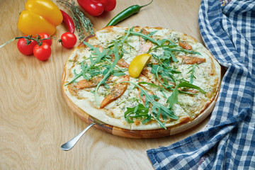 Italian, homemade pizza with salmonon dor blue cheese a wooden table. Top view food with copy space. Flat lay