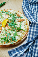 Italian, homemade pizza with salmonon dor blue cheese a wooden table. Top view food with copy...