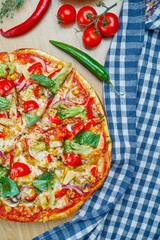 Italian, homemade vegetarian pizza with mushrooms, onions and broccoli on a wooden table on a wooden table. Top view food with copy space. Flat lay