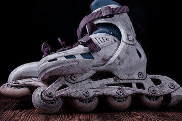 Worn roller skates on a dark background