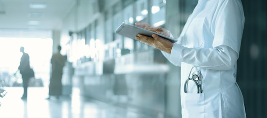Healthcare and medicine. Medical and technology. Doctor working on digital tablet on hospital...
