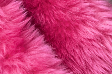 Pink bright fur background close-up texture.