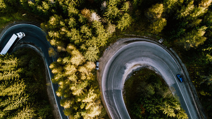 Aerial view of mountain curved road with truck heavy traffic. Asphalt serpentine roads details 