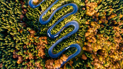 Details of curvy Europe road with heavy traffic and autumnal scenery