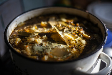 Cooking homemade soup. Tasty food in the workshop. Vegetable soup is cooked in a pan.