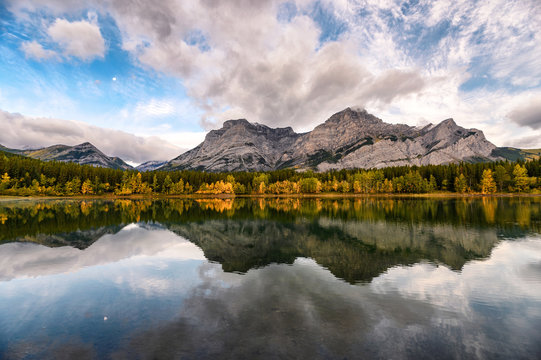 Canadian rockies with the moon reflection on Wedge pond in the morning at Kananaskis country