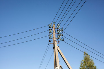 Electrical wires on a pole. Communication networks on high voltage poles. High voltage.