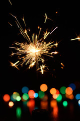 Obraz premium Bengal fire burning on a color blurred background.