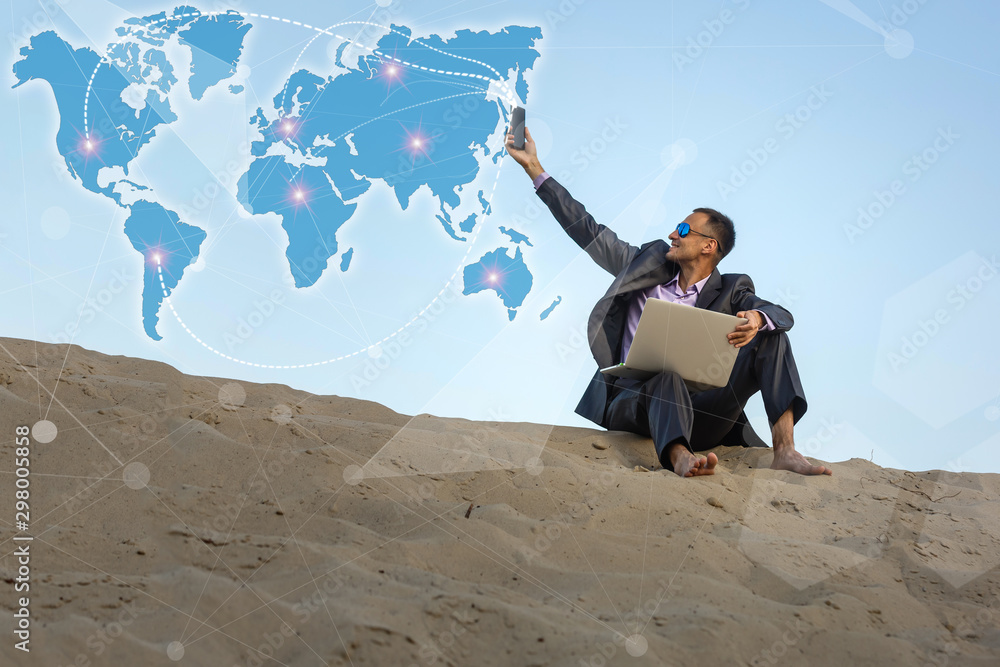 Aufkleber man using computer on the world map.