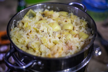 Apples are stewed in a saucepan. Cooking apples. Casserole for cooking products. Apples are cut into pieces and stacked in a bowl.