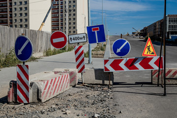 Work in progress. Roadworks, road signs. Men at work. Some signs signage for work in progress on...