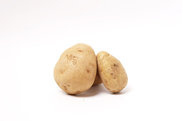Three fresh brown potatoes raw isolated white background