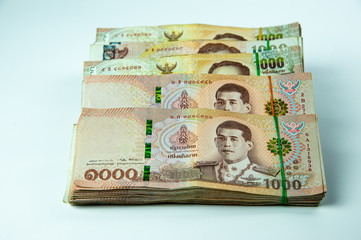 Stacked of Thai money bank notes on white background.