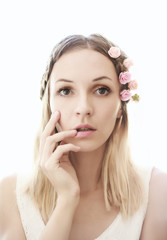 Fototapeta premium Hight key portrait of beautiful young woman with flowers in hair. Soft focus.