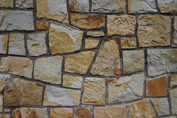 old stone wall of the building on the street