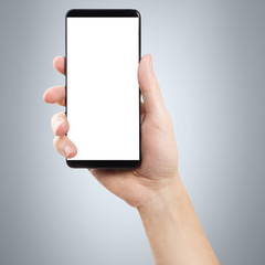 Hand with smartphone on gray background