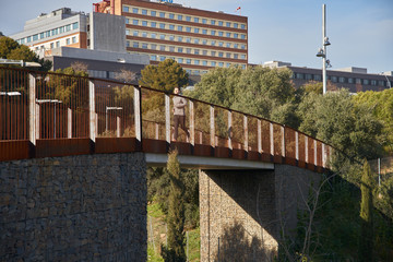 Man in the distance running across a bridge