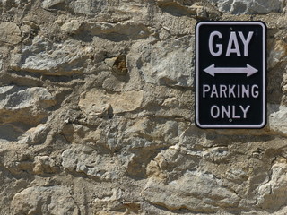 parking sign on stone wall