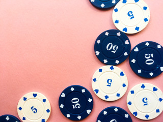 Poker chips on a pink background. Place for text.