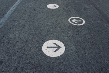 arrow road sign on the road on the street in the city