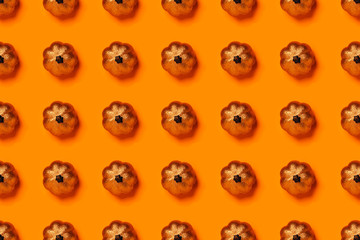 Naklejka premium Halloween pattern of skeletons on orange background.