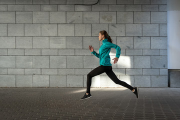 Young adult athlete woman jogging outdoor in city - Powered by Adobe