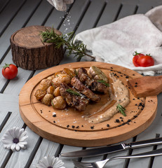 fried meat and mushrooms on wooden board