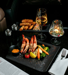 fried shrimps roulets and vegetables with shampaigne