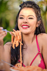 beautiful Woman in her underwear eats Italy spaghetti pasta with meat and wine in Italy house garden