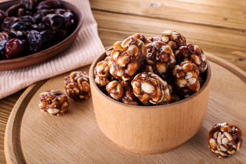 Vegan delicious sweet cocoa and almond balls on wooden table healthy food