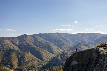 Relaxed tourist admiring the view from the mountain top,hiking concept, Panoramic view landscape from mountain, Bulgaria