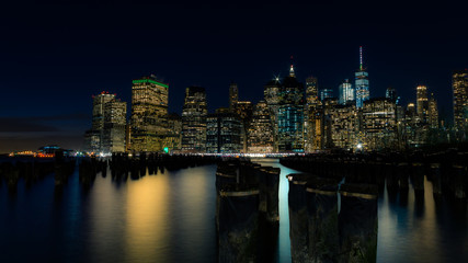 Fototapeta na wymiar Lower Manhattan at night with the old pier posts