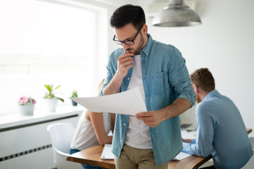 Fototapeta premium Young group of people architects discussing business plans