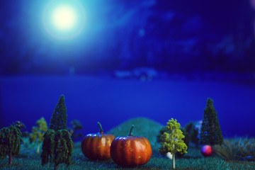 Halloween Pumpkins in a forest in a clearing in the moonlight Halloween background. Fairy tale. Macro. Artificial magic dreamy world.