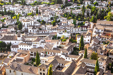 Fototapeta na wymiar Historical district Albaicin in Granada, Spain photographed from above. Narrow winding streets with traditional buildings dating back to medieval Muslim rule over the city. Moorish architecture
