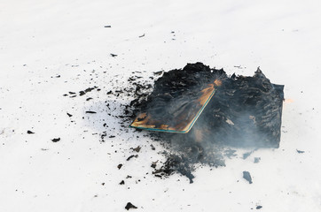 burning book in  snow. pages with the text in  open book burn with  bright flame.