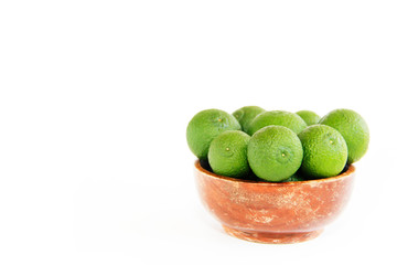 green fresh natural tangerines oranges in a brown plate