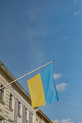 Flag of Ukraine on a building against a blue sky