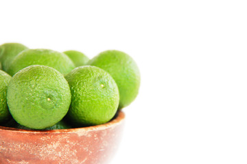 green fresh natural tangerines oranges in a brown plate