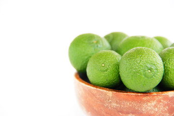 green fresh natural tangerines oranges in a brown plate