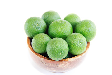 green fresh natural tangerines oranges in a brown plate