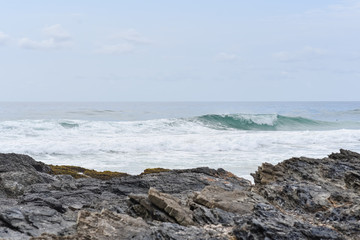 Rocks and sea at Snapper Rocks on the Gold Coast Australia.  White sea wash with waves over a rocky coastline.