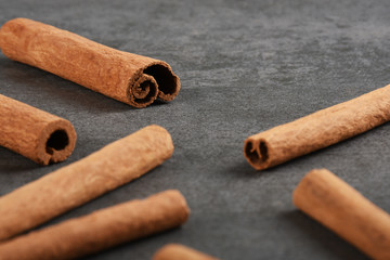 Cinnamon sticks on the gray stone texture with copy space	