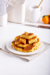 Homemade citrus sponge cake. Orange biscuit on white table.