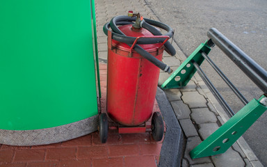 Large fire extinguisher at a gas station.