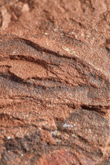 Grainy texture of reddish-orange natural stone. Natural backgrounds and textures. Construction and finishing.